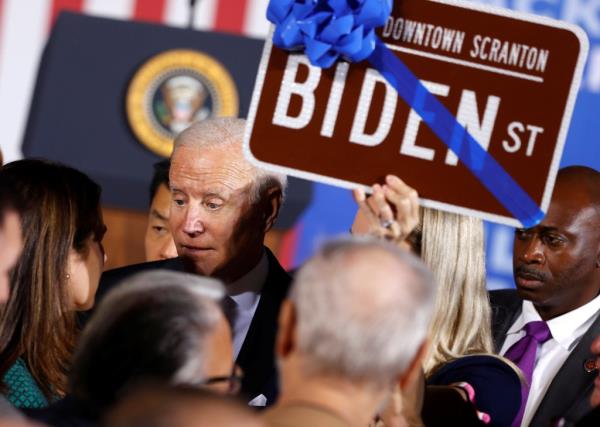 Biden receives a Biden Street sign following a speech in 2021.