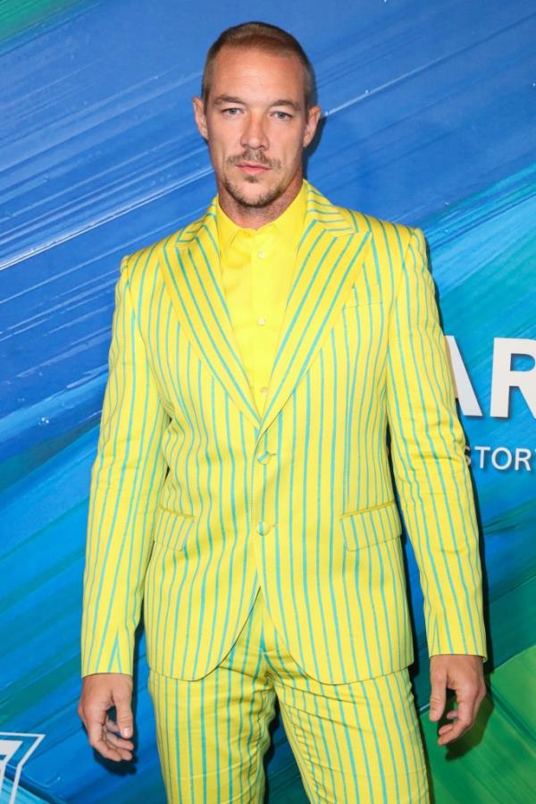 Photo of DJ Diplo in a green striped suit. 
