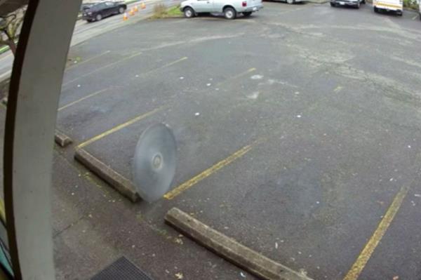 saw blade rolling through parking lot