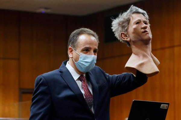 Deputy District Attorney Habib A. Balian holds a rubber latex mask, worn by Robert Durst