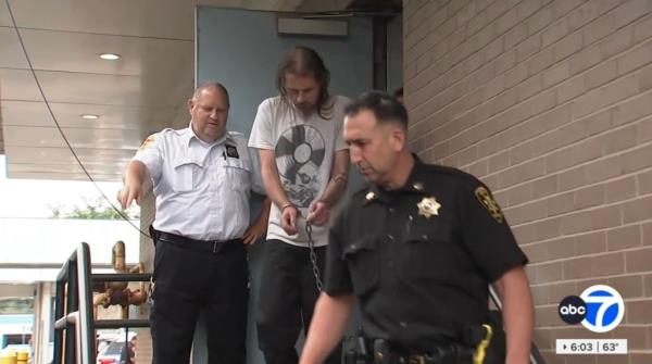 Ro<em></em>nald Schroeder in cuffs led by cops