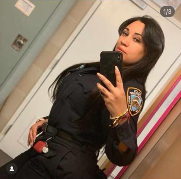 A photo of Baez posing for a selfie with her cell phone.