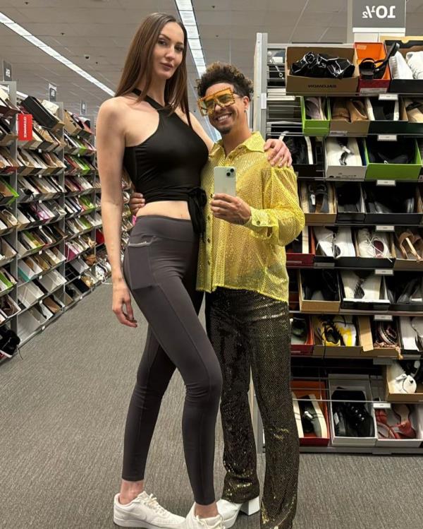 Lisina, seen here standing next to a man in a yellow shirt who o<em></em>nly reaches her chin.