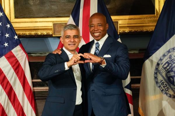  Adams meets with Lo<em></em>ndon Mayor Sadiq Khan at City Hall on Wednesday, Sept. 20 - and makes another hand heart. 