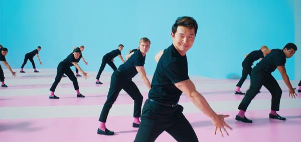 Simu Liu in black, danging. 