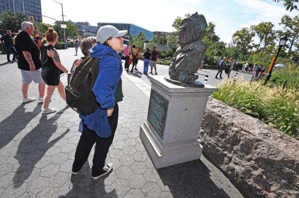 A man looks at the sculpture. 