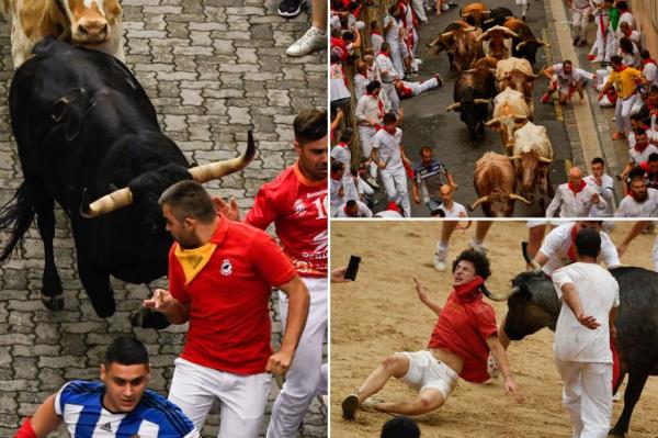 People participating in the famous running of the bulls in the streets of Pamplona on the first day of the festival.