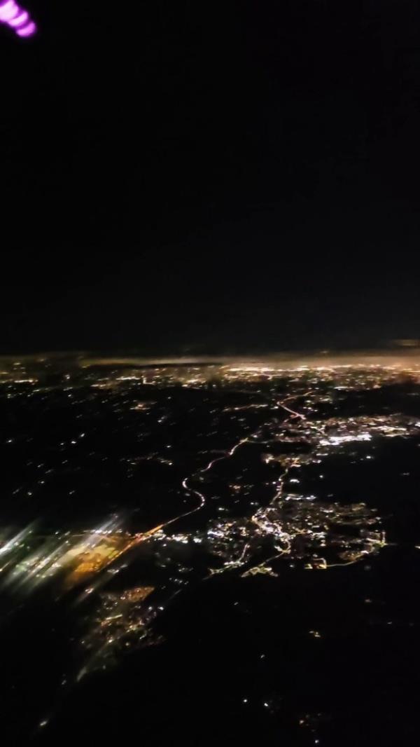 The flight attendant said she was getting a quick video of the view, without even noticing the pink light in the upper corner.