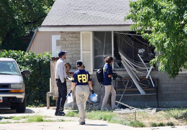 Law enforcement investigate the scene of the deadly shooting on Wednesday, Aug. 9.
