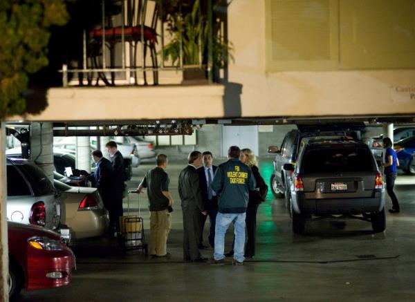 FBI agents stand in the ground floor parking garage of the apartment building in Santa Monica, Calif., wher<em></em>e fugitive crime boss James