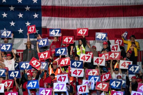 people at rally holding up the number 47