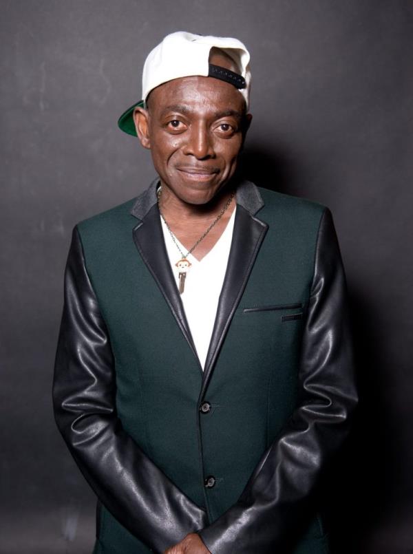 Hinton Battle poses in a white hat backstage for a press preview at 54 Below.
