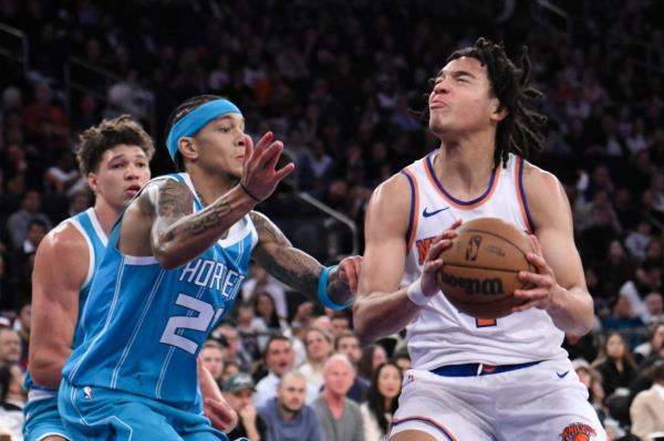 New York Knicks guard Pacome Dadiet (4) drives to the basket while being defended by Charlotte Hornets guard Tre Mann (23) during the first half at Madison Square Garden. 