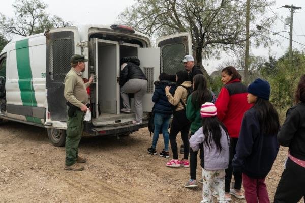 A group of newly arrived migrants boarding the US Border Patrol van to be taken to a make-shift transit center after crossing the Rio Grande river into the US from Mexico in Eagle Pass, Texas, on Friday.
