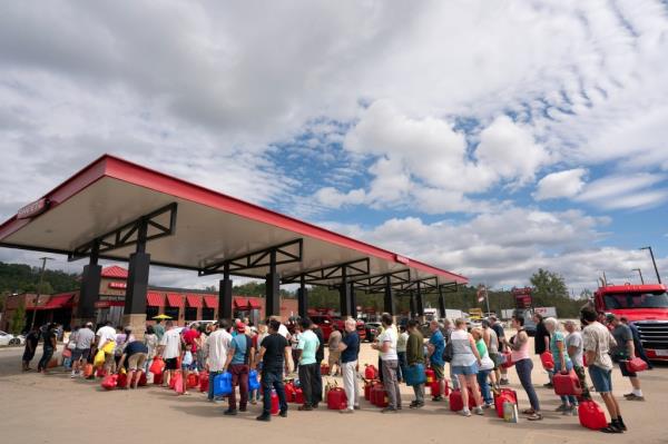 People wait in line at a gas station in the aftermath of Hurricane Helene.