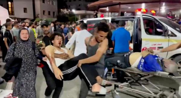 An injured person is taken into a hospital after hundreds of Palestinians were killed in a blast at Al-Ahli hospital in Gaza that Israeli and Palestinian officials blamed on each other in Gaza City, Gaza Strip on Oct. 17, 2023.  