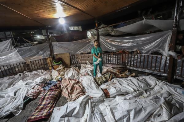 Bodies of Palestinians killed in an Israeli shelling on the Ahli Arab hospital, lie at al-Shifa hospital in Gaza City. 