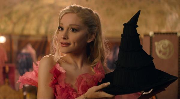 Ariana Grande holding a witch's hat in Wicked