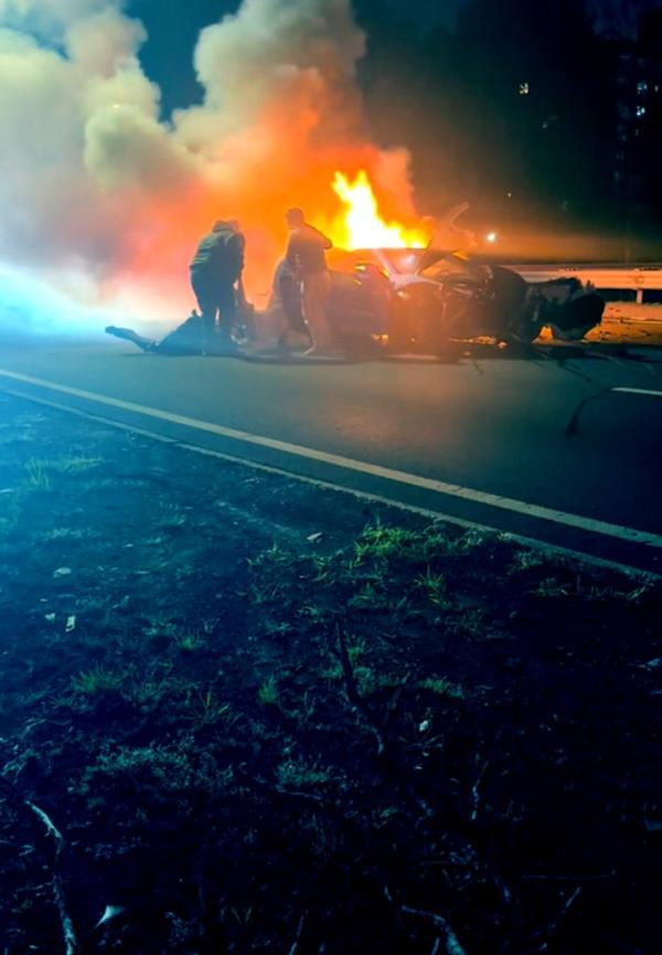 A BMW and a Corvette crashed in the middle of the highway.