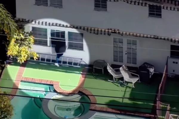 Drone video shows suspect climbing out a window at a Beverly Hills home on Jan. 6 
