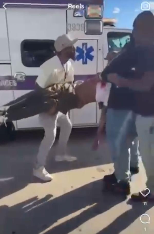 A wounded victim is carried to an ambulance following the stabbing.