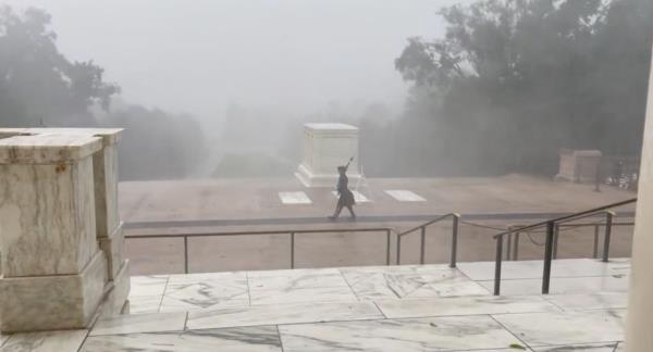 A soldier co<em></em>ntinues watch over Tomb of the Unknown Soldier as hurricane-force winds, rain lash DC area.