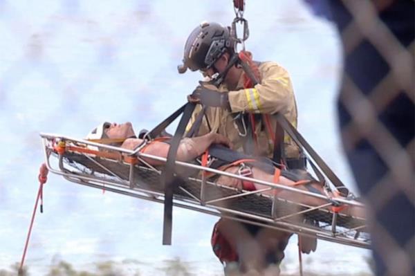 Rescuers put the man in a stretcher.