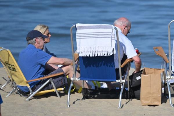Jill Biden (L) sits with Joe Biden (R) on the beach in Rehoboth Beach, Delaware on August 13, 2023.