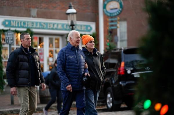President Joe Biden walks with his granddaughter Maisy Biden as he visits local shops with family in Nantucket, Mass., Saturday, Nov. 25, 2023.
