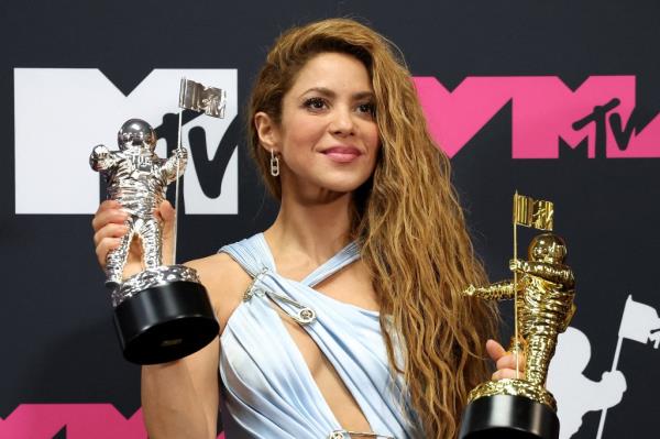 Shakira poses with her Video Vanguard Award and her and Karol G's Best Collaboration Award for 