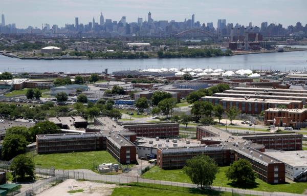 The Rikers Island jail complex stands in New York with the Manhattan skyline in the background.
