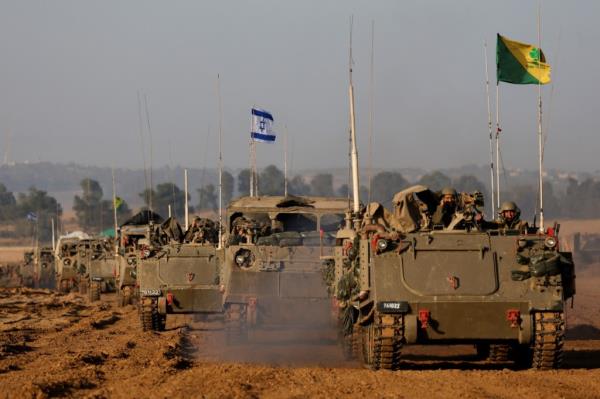 An Israeli flag is seen on a military vehicle as a co<em></em>nvoy of Israeli military tanks and Armoured Perso<em></em>nnel Carriers (APC) drives by Israel's border after leaving Gaza during the temporary truce between the Palestinian Islamist group Hamas and Israel, in Israel, on Nov. 24, 2023. 