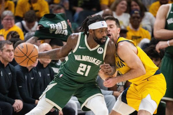 Milwaukee Bucks guard Patrick Beverley (21) dribbles the ball while Indiana Pacers guard T.J. McCo<em></em>nnell (9) defends during game six of the first round for the 2024 NBA playoffs at Gainbridge Fieldhouse.  
