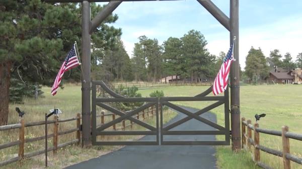 A gate adorned with American flags on Metz's property