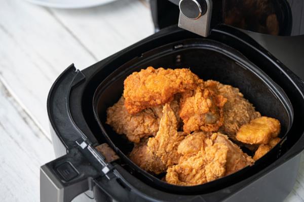 Chicken being cooked in an air fryer