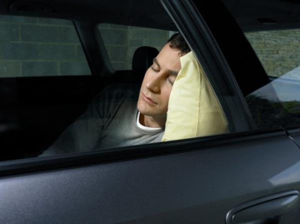 Man sleeping in car