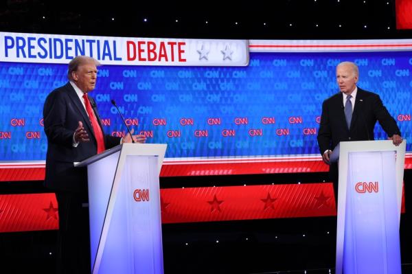 U.S. President Joe Biden and former President Do<em></em>nald Trump participating in the CNN Presidential Debate at a podium in Atlanta, Georgia on June 27, 2024