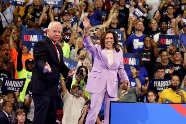 Vice President Kamala Harris and Minnesota Gov. Tim Walz on stage at a campaign rally in Las Vegas on Aug. 10, 2024.