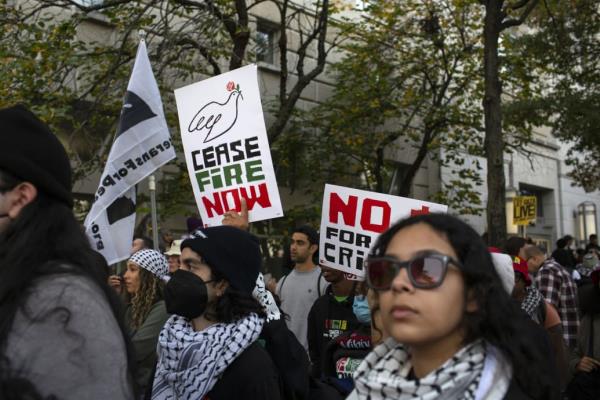 A photo of a demo<em></em>nstrator holding a sign with ‘Ceasefire Now’ written on it, at a pro-Palestinian march in Washington, D.C. on November 4.