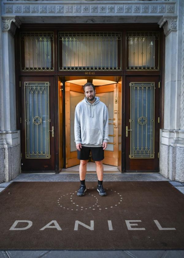 New York Post reporter Jon Levine stands dejectedly outside of the restaurant Daniel in New York City