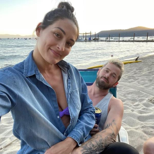 Artem Chigvintsev and Nikki Bella taking a selfie.