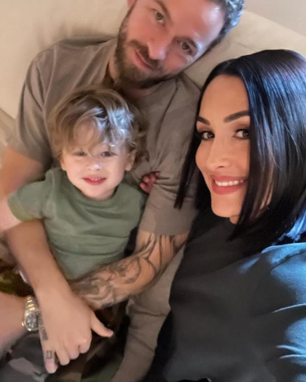 Artem Chigvintsev and Nikki Bella with their son.