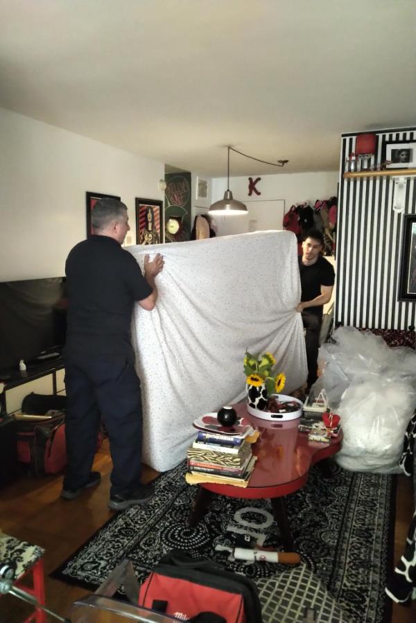 Building staff moving Kreth's bed from her unit.