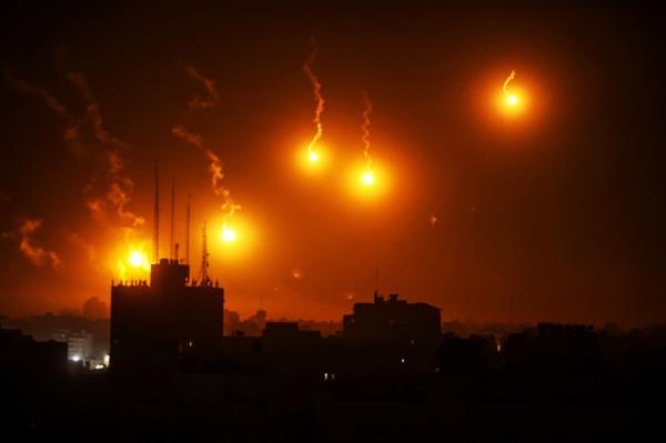 A lighting flare, fired by Israel illuminates the sky in Al-Sudaniya, region in the northwest of Gaza on Oct. 30, 2023. 