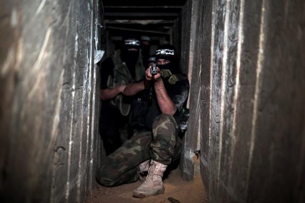 Armed Izz ad-Din al-Qassam Brigades, military wing of Hamas, deploy at a tunnel in Shujaya neighborhood of Gaza City, Gaza. 