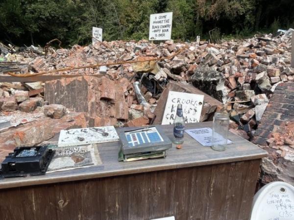 The demolished Crooked House pub near Dudley, West Midlands. Work has begun to fence off the remains of the pub, more than a week after its burnt-out shell was demolished following a suspected arson attack. Workers at the site in Himley, said the immediate area was being sealed off with fencing for safety reasons, following protests against the pub's destruction which saw signs and other tributes placed among the rubble. Picture date: Tuesday August 15, 2023. PA Photo. See PA story FIRE Crooked. Photo credit should read: Matthew Cooper/PA Wire