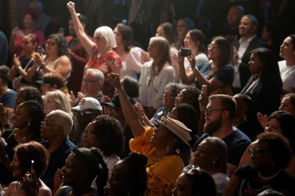 Supporters raising their fists as U.S. Vice President Kamala Harris discusses reproductive rights on the second anniversary of Roe v. Wade being overturned, in Phoenix, Arizona
