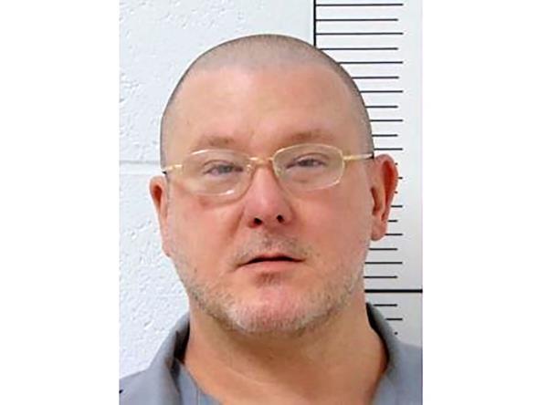 Brian Dorsey, a white, balding man wearing glasses, in his mugshot.