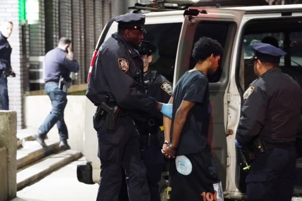 Cops place a suspect in a police van