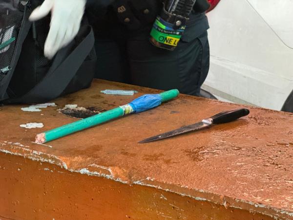 A knife and stick recovered by cops at the crime scene.